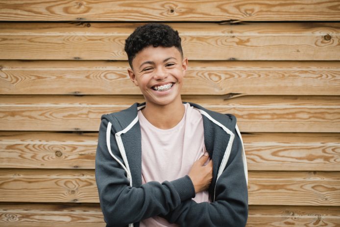 Middle school boy smiling wide with metal braces