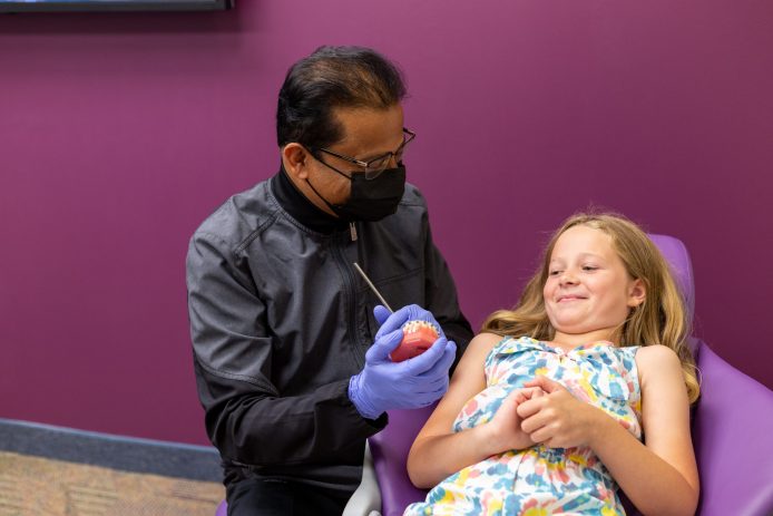 Dr. Ghosh explains treatment to a young patient