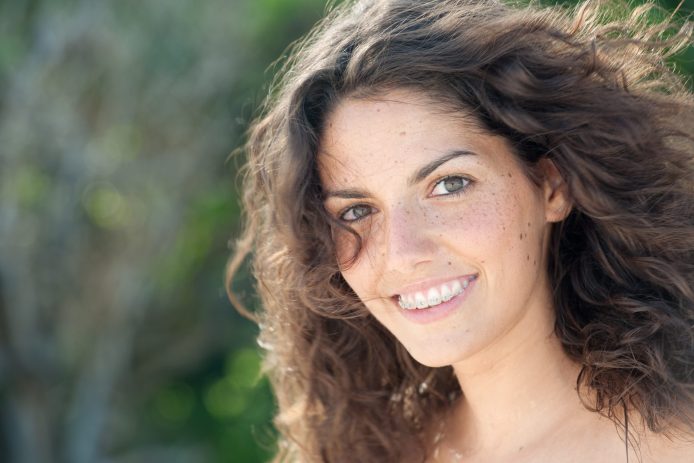 Teenage girl smiling with clear braces