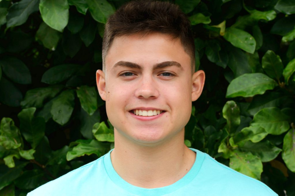 A A teen boy smiles after orthodontic treatment at Ghosh Orthodontics