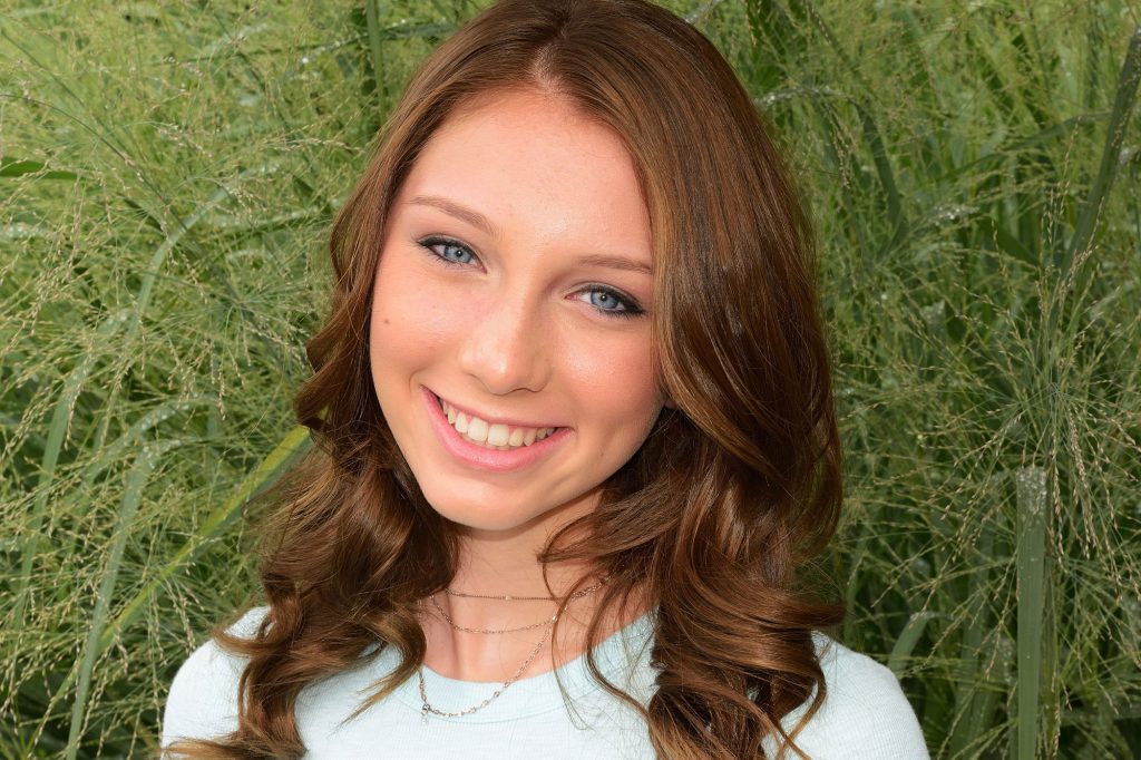 A teen girl smiles after orthodontic treatment at Ghosh Orthodontics