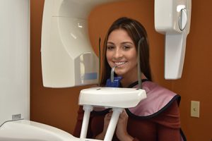 A young woman smiles during her appointment at Ghosh Orthodontics